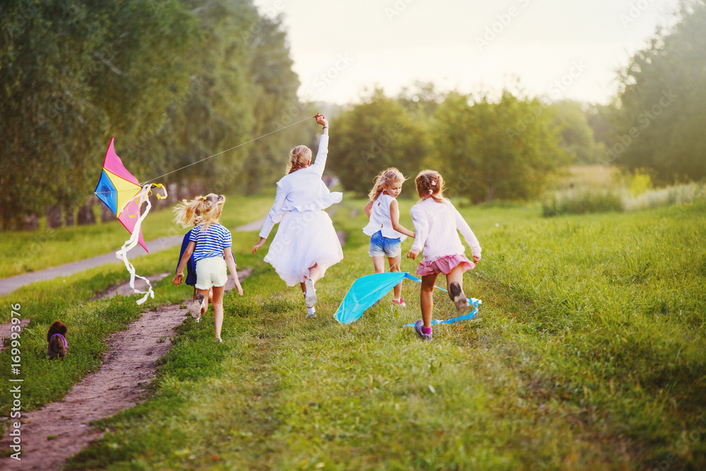 Fototapeta premium happy children in summer nature, flying a kite