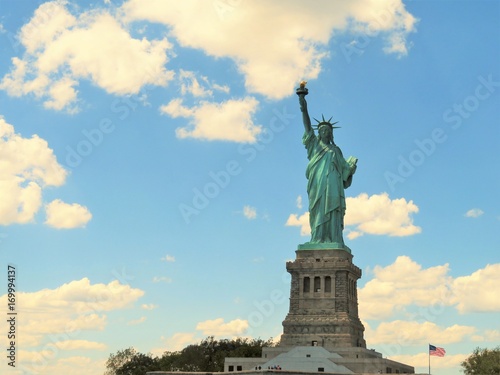 The Statue of Liberty in New York City with a blue sky background
