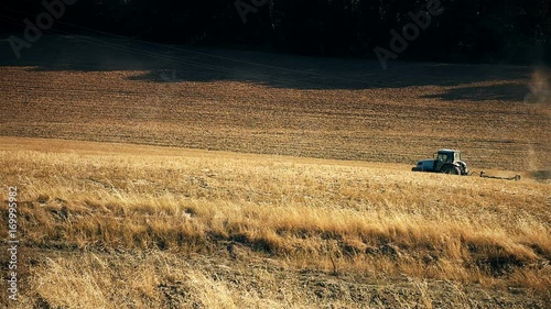 Tractror on the farm field, Tuscany, Italy. photo