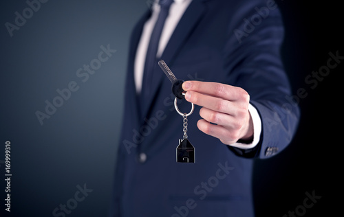 Young man hand over keys