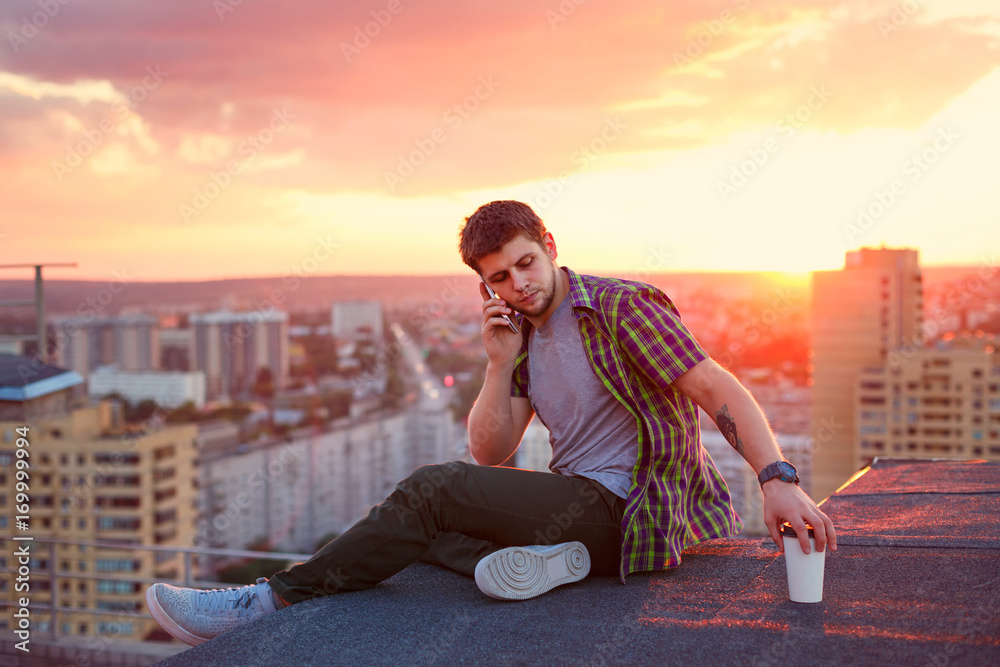 Man talking on phone and drinking coffee Man talking on phone and drinking coffee