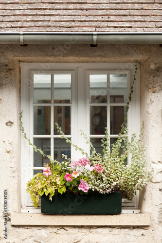 Cozy window of old house in Saint Guilhem le Desert village protected by UNESCO  France
