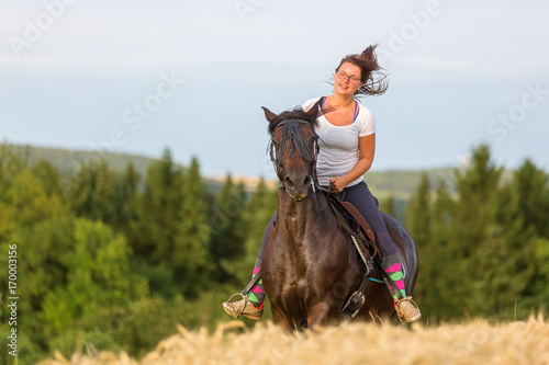 woman rides an Andalusian horse