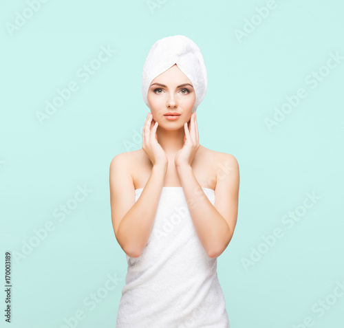 Wallpaper Mural Young, beautiful and natural woman wrapped in towel over cyan background. Torontodigital.ca