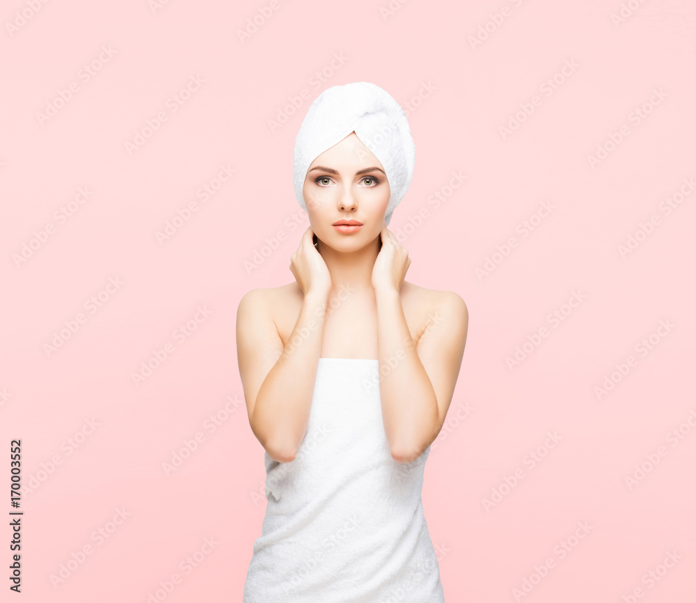 Young, beautiful and natural woman wrapped in towel over orange background.