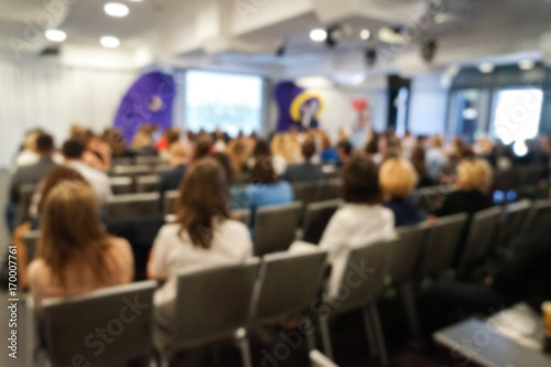 Blurred business people sitting in conference hall © Africa Studio