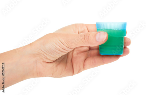 female hand holding cup with detergent. Isolated on white background
