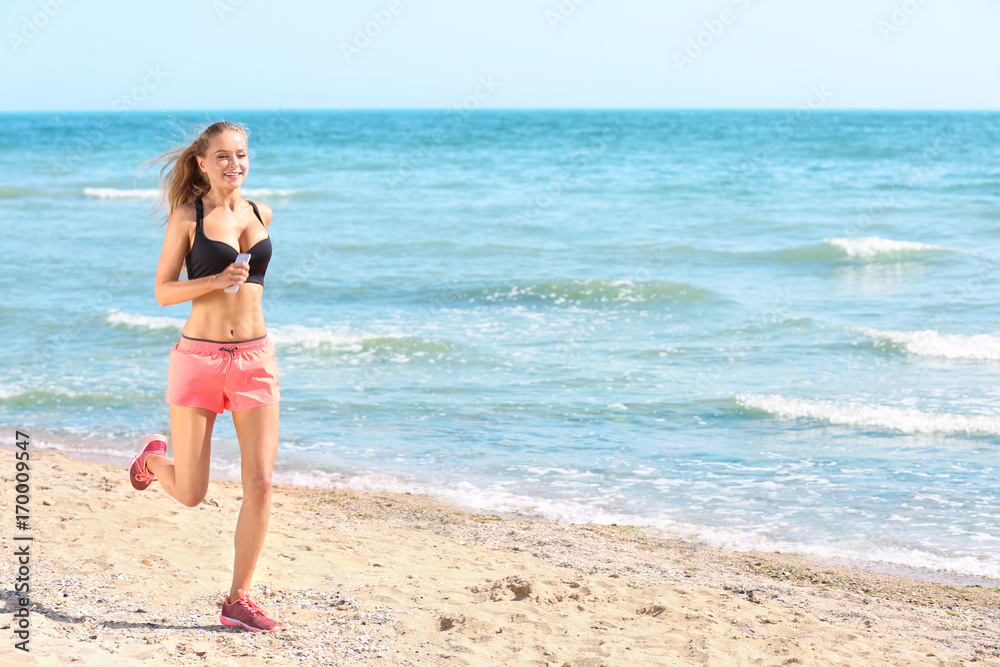 Beautiful young woman running on sea beach Beautiful young woman running on sea beach