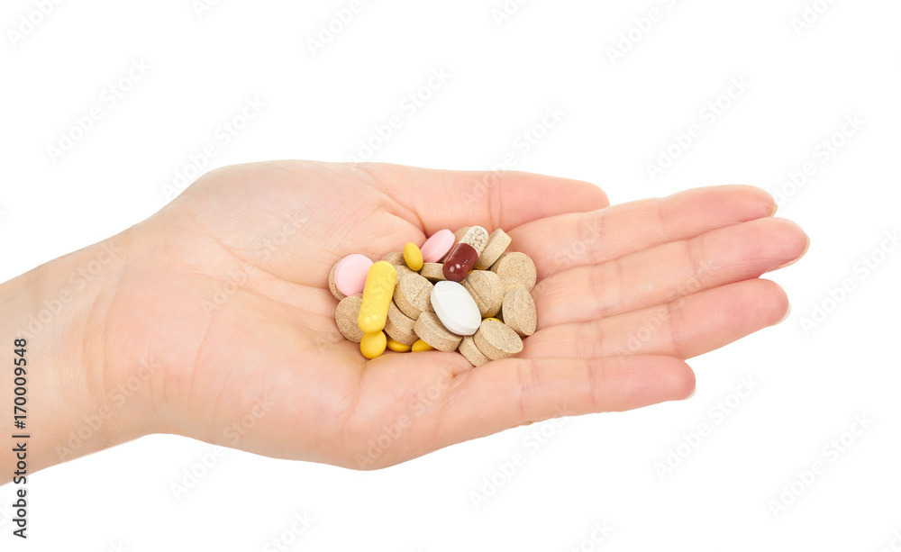 female hand holding pills. Isolated on white background female hand holding pills. Isolated on white background