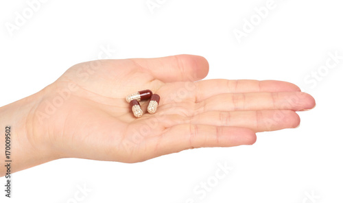female hand holding pills. Isolated on white background