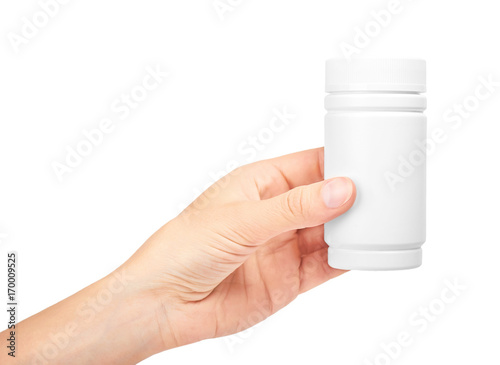 female hand holding bottle with pills. Isolated on white background
