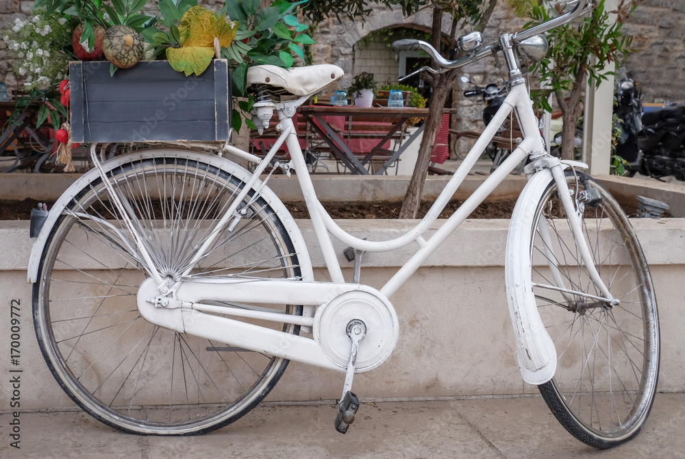 Vintage white bicycle on city street