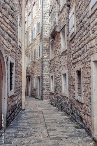 View of picturesque narrow street with lattice windows on both sides