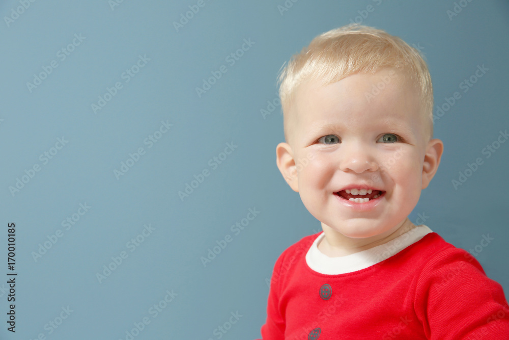 Happy little child in Santa costume on grey background Happy little child in Santa costume on grey background