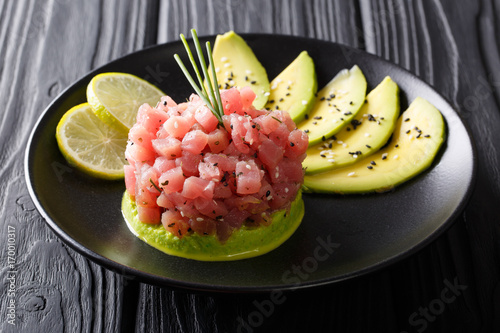 Beautiful food: fresh tuna tartar with lime, avocado and sesame close-up. horizontal