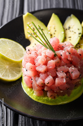 Tartar from tuna served with avocado and lime macro. vertical