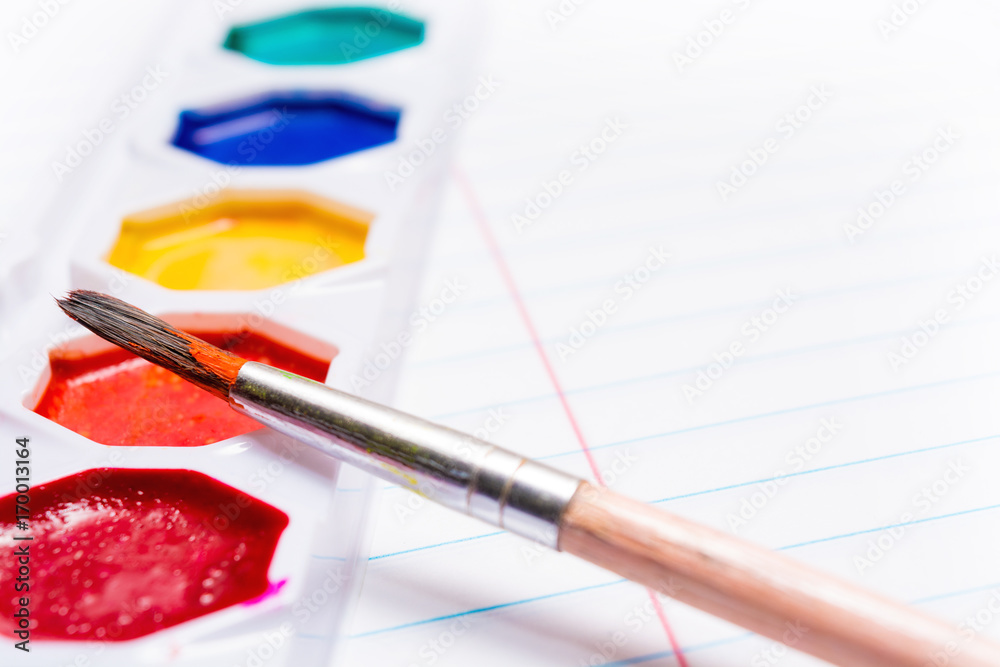 Fototapeta premium Brush and Bright colored watercolor paints. Back to school. Stationery.