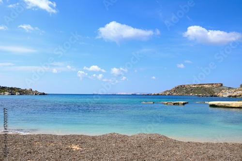 Fototapeta Naklejka Na Ścianę i Meble -  View of Ghaja Tehheiha Bay with a pebble beach in the foreground, Ghajn Tuhheiha Bay, Malta.