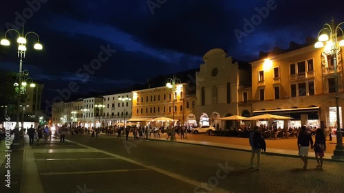 People walking by night in the Belluno main square, Veneto, Italy