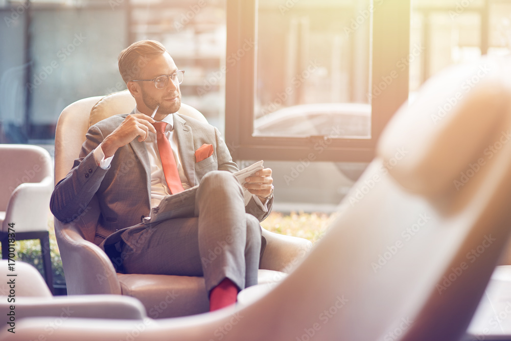 Fotografie Positive businessman sitting in the departure lounge