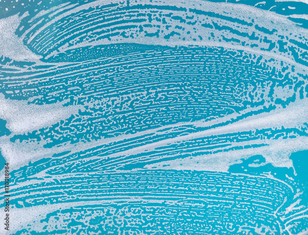 soap foam on a blue background - obrazy, fototapety, plakaty 
