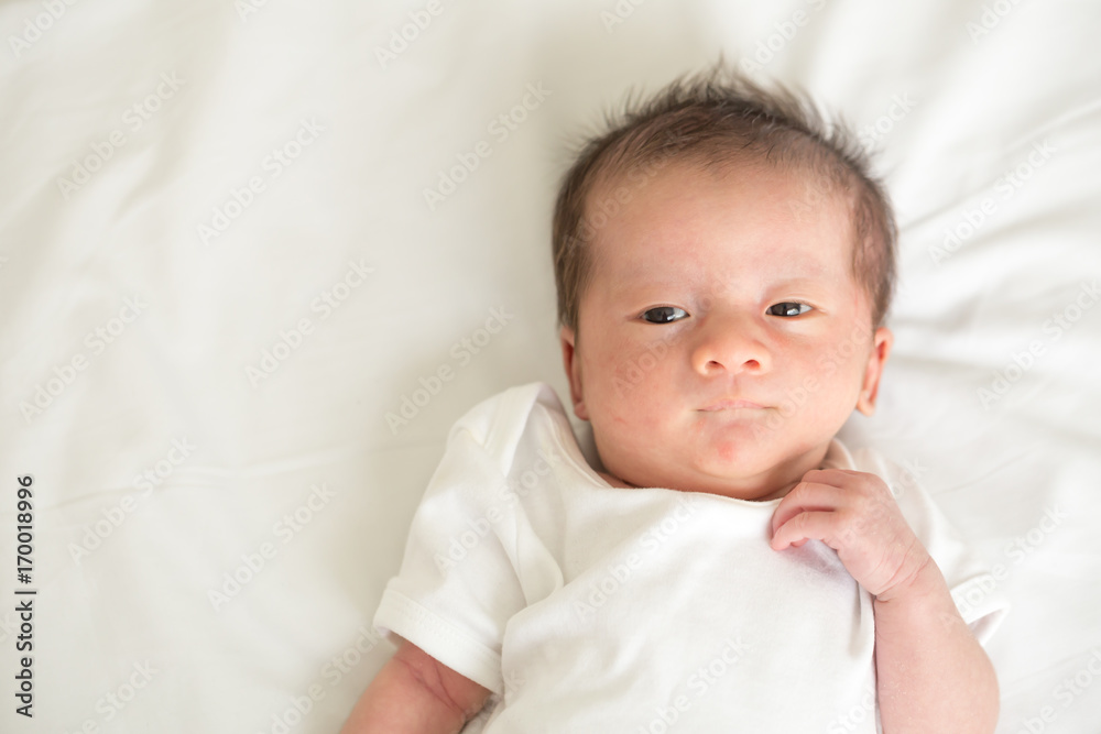 Asian newborn baby lying on the bed,Three week old Asian newborn baby lying on the bed,Three week old