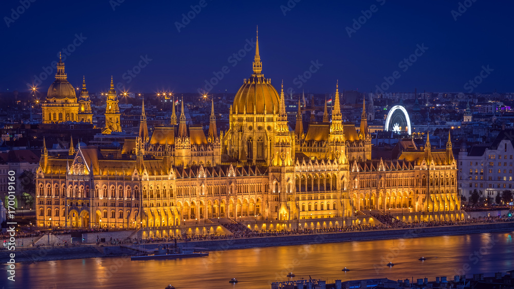 Budapest, Hungary - Panoramic skyline view of the beautiful illuminated Parliament of Hungary and St Stephens Basilica at blue hour