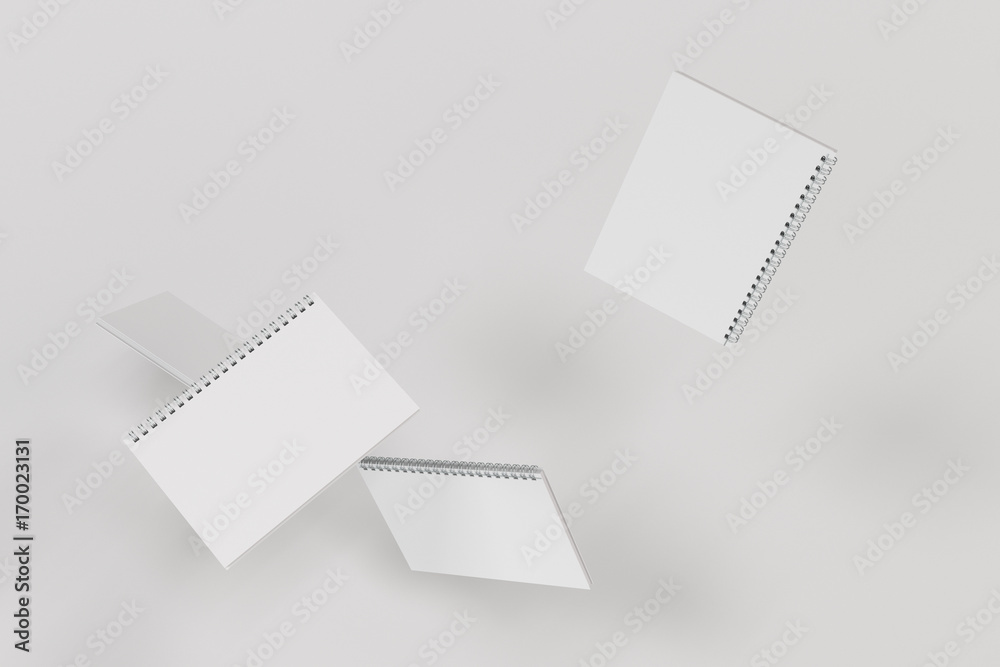 Four notebooks with spiral bound on white background Four notebooks with spiral bound on white background