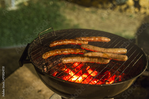 Grilling saussages at night photo