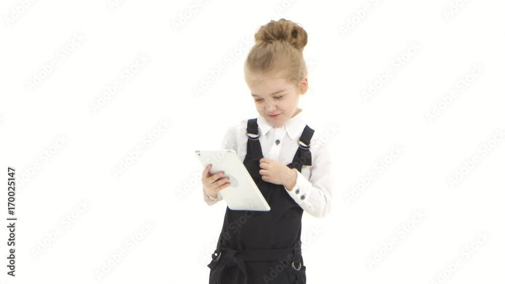 Little girl business lady talking online on tablet, white background Little girl business lady talking online on tablet, white background