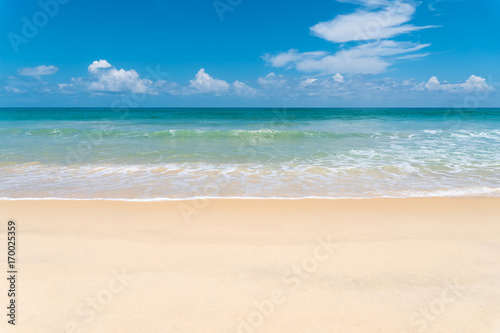 Tropical beach with blue sky and white cloud background.
