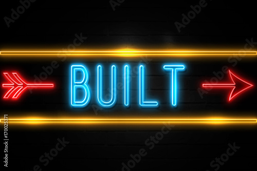 Built - fluorescent Neon Sign on brickwall Front view