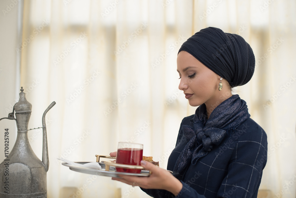 young woman wearing hijab holding tray young woman wearing hijab holding tray