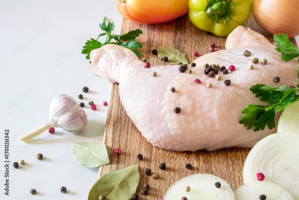 Chicken leg on wood near garlic Chicken leg on wood near garlic