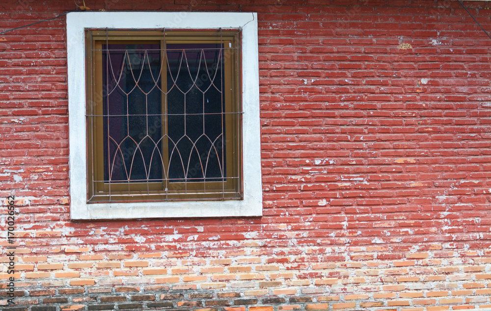 Red brick wall with a window.