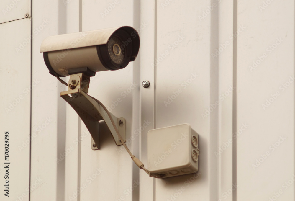 Camera surveillance on the wall of the building.