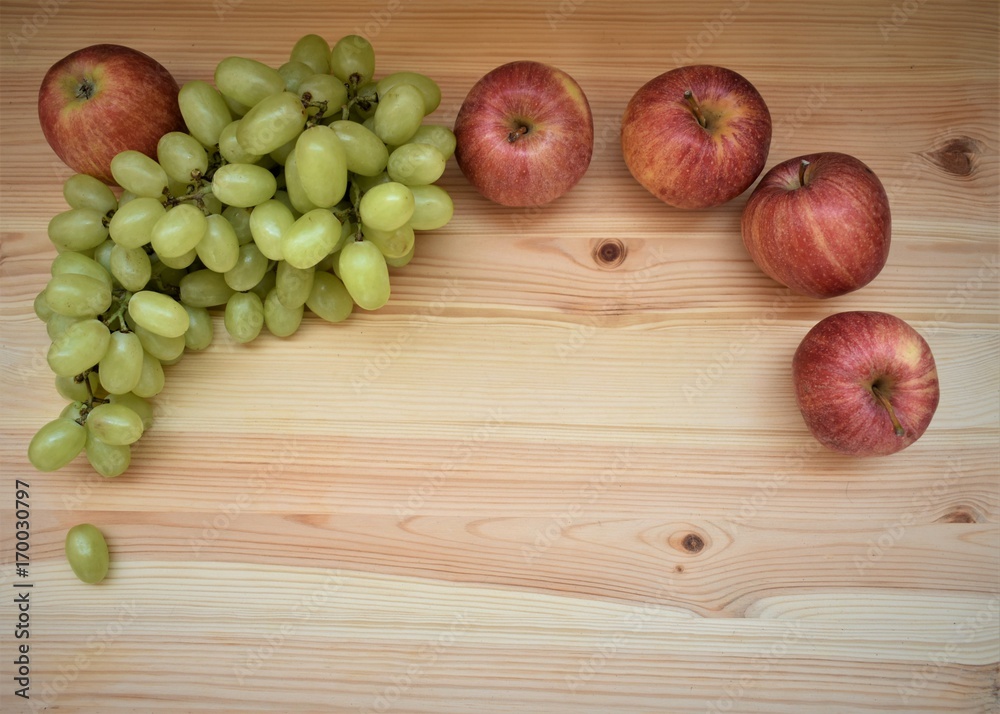 Apples and grapes on the wooden table, copy space. Apples and grapes on the wooden table, copy space.