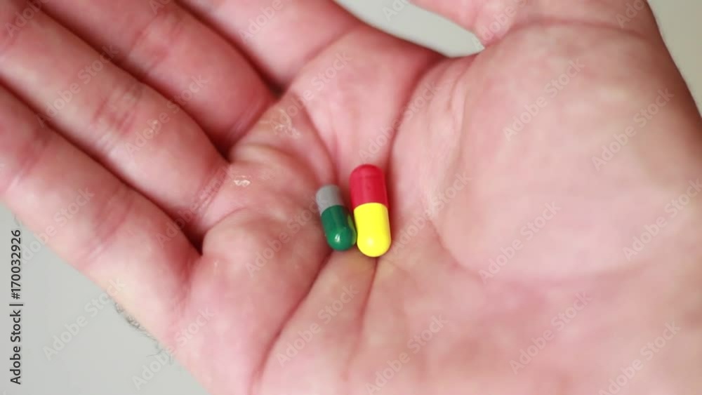 Pills in male palm closeup Pills in male palm closeup