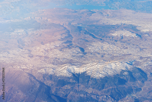 View of the mountains from the height of the aircraft, toned image. © Stanislav Samoylik