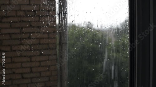Close up drops of rain on window pane