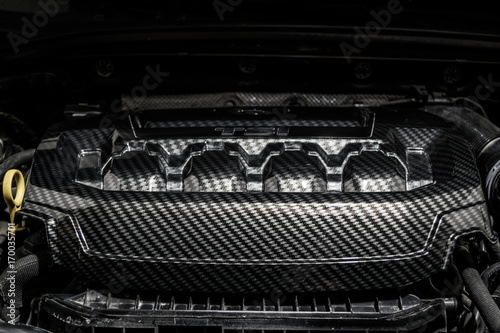 Close up detail of car engine, carbon fiber part