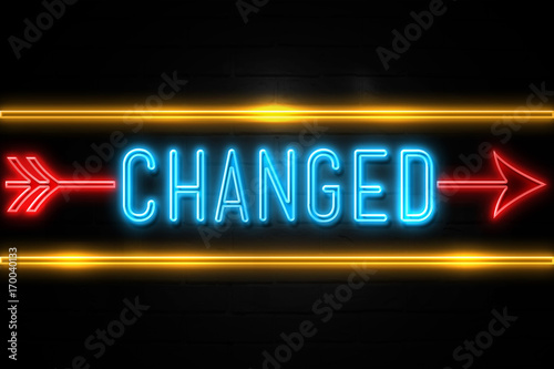 Changed  - fluorescent Neon Sign on brickwall Front view