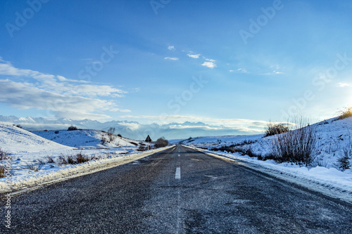 Winter road under the mountains