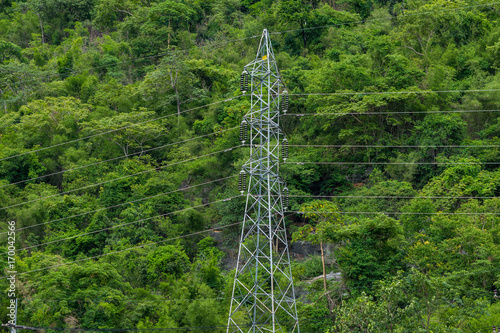 High voltage pole with green nature background