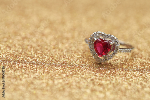 red gemstone on diamond ring