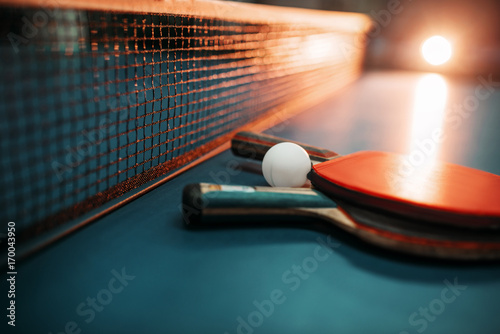 Two tennis rackets and ball against net on table © Nomad_Soul