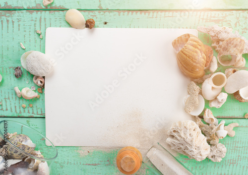Blank paper with shells, coral on wood table,top view