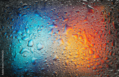 Complementary colors oil drops and water drops on glass,abstract background