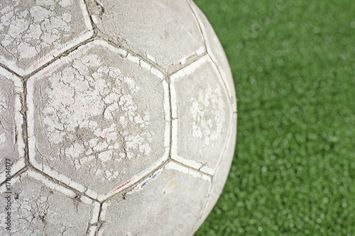 Old football on artificial turf