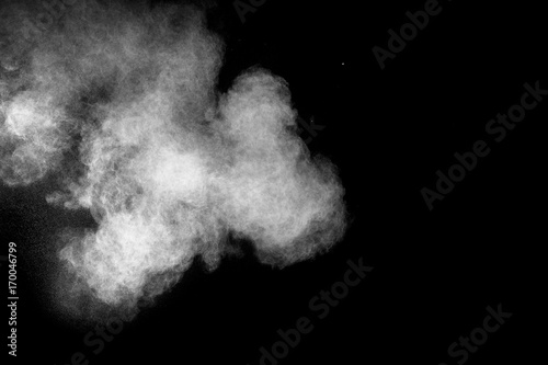 Launched white powder isolated on black background.